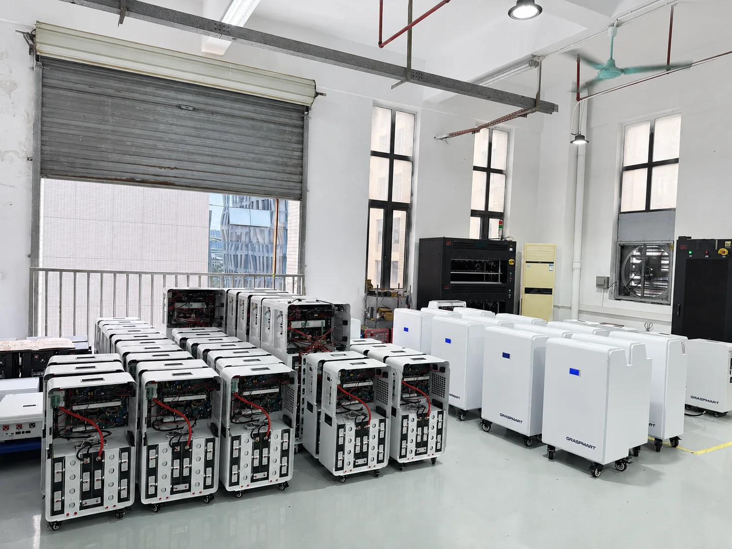 Residential battery systems in batch assembly with internal modules and wiring visible